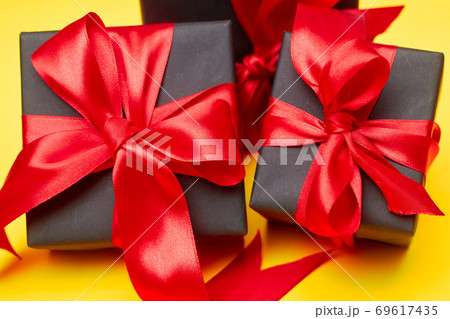 Black friday sale flat lay with gift box and ribbon, copy space, christmas and holidays concept on yellow background Black friday sale flat lay with gift box and ribbon, copy space, christmas and holidays concept on yellow background 69617435