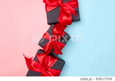 Black friday sale flat lay with gift box and ribbon, copy space, christmas and holidays concept on pink blue background Black friday sale flat lay with gift box and ribbon, copy space, christmas and holidays concept on pink blue background 69617436