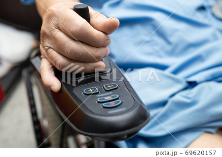 Asian senior lady patient on electric wheelchair in hospital. Asian senior lady patient on electric wheelchair in hospital. 69620157