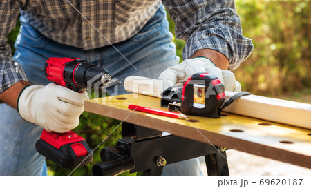 Carpenter at work on wooden boards. Carpentry. Carpenter at work on wooden boards. Carpentry. 69620187