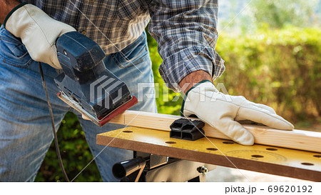 Carpenter at work on wooden boards. Carpentry. 69620192