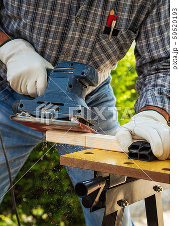 Carpenter at work on wooden boards. Carpentry. 69620193