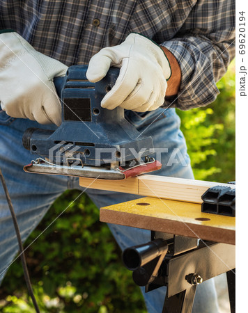 Carpenter at work on wooden boards. Carpentry. 69620194