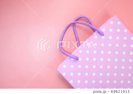 women gift bag on pink background top view. women gift bag on pink background top view. 69621913