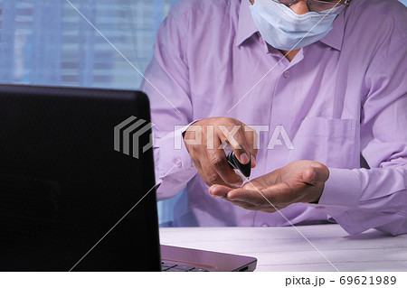 businessman using sanitizer gel on on office desk businessman using sanitizer gel on on office desk 69621989