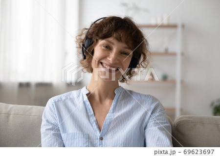Portrait of young woman in headset talk on video call Portrait of young woman in headset talk on video call 69623697