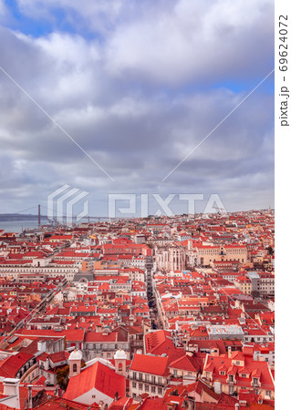 Beautiful panoramic view of Lisbon city with red tiled roofs under a cloudy sky. Beautiful panoramic view of Lisbon city with red tiled roofs under a cloudy sky. 69624072