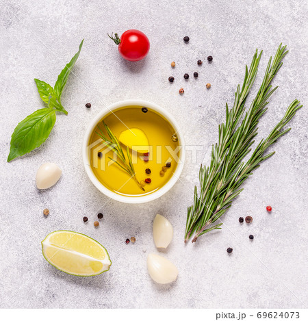 Herbs and condiments on light stone background. 69624073