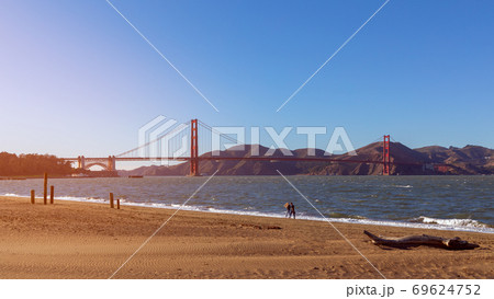 Beautiful view from Crissy Field beach of famous Golden Gate Bridge In the light of the setting sun. 69624752