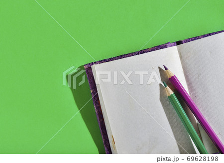 Opened notebook with colored pencils Opened notebook with colored pencils 69628198