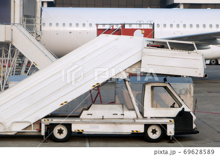 Passenger ladders for boarding passengers in an airplane. Airplane stairs prepared for boarding. Passenger ladders for boarding passengers in an airplane. Airplane stairs prepared for boarding. 69628589
