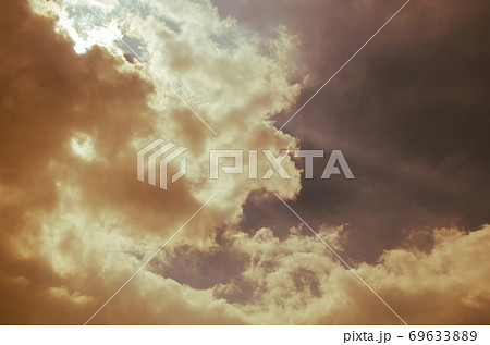 Sunlight Shining Through the Cloud in Warm Color Theme. 69633889