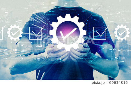 Quality control approval with man holding smartphone Quality control approval with man holding smartphone 69634316