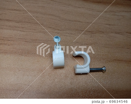 white colored wire pin on wooden table 69634546