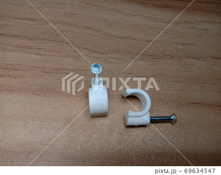 white colored wire pin on wooden table 69634547