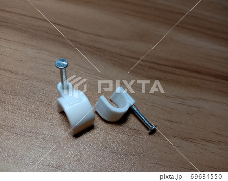 white colored wire pin on wooden table white colored wire pin on wooden table 69634550