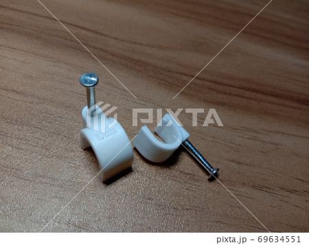 white colored wire pin on wooden table white colored wire pin on wooden table 69634551