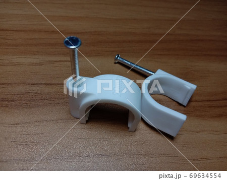 white colored wire pin on wooden table white colored wire pin on wooden table 69634554