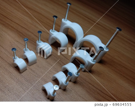 white colored wire pin on wooden table white colored wire pin on wooden table 69634555