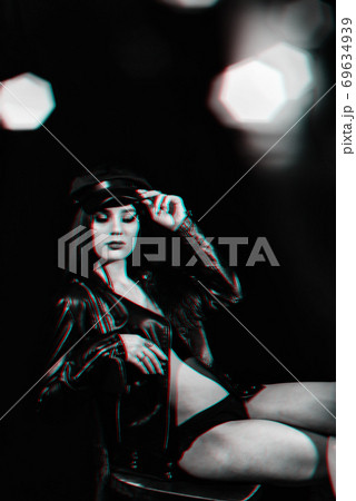 stylish portrait of a young girl in a leather jacket and cap 69634939