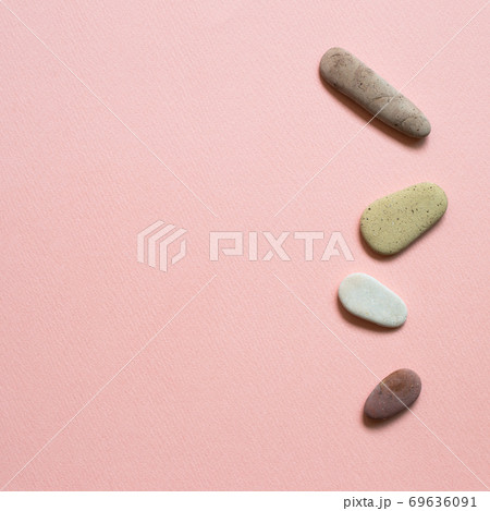 Natural pebble stones on pink background. top view, copy space Natural pebble stones on pink background. top view, copy space 69636091