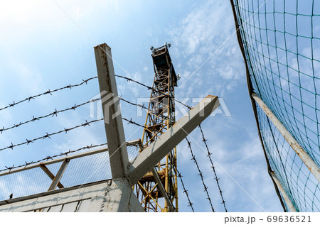 fence barbed wire and watchtower on the border Ukraine 69636521