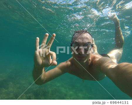 man swims under water man swims under water 69644131
