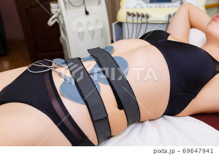 Modern muscle myostimulation in the massage room. 69647941