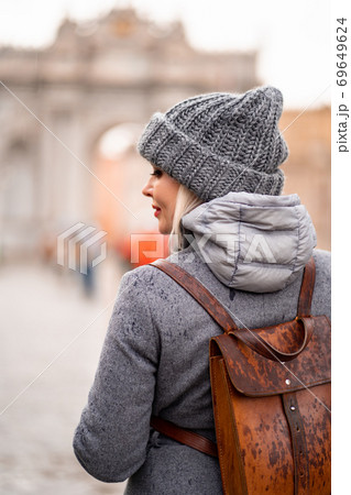girl back in coat and hat on the street in rain girl back in coat and hat on the street in rain 69649624