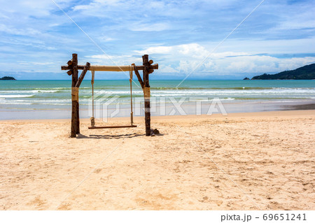 Exotic tropical paradise swings over crystal clear turquoise blue ocean sea water landscape seascape at Patong Beach, Phuket, Thailand 69651241