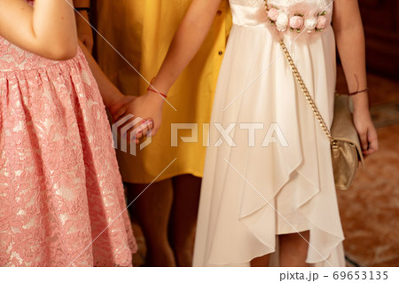 guests wedding without faces hold hands in Church. guests wedding without faces hold hands in Church. 69653135