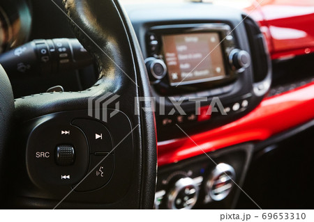 Audio system and Voice dialing control buttons on steering wheel. Car interior. Shallow dof 69653310