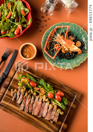 Beef steak on a wooden background.  69653774