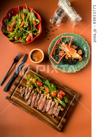 Beef steak on a wooden background.  69653775