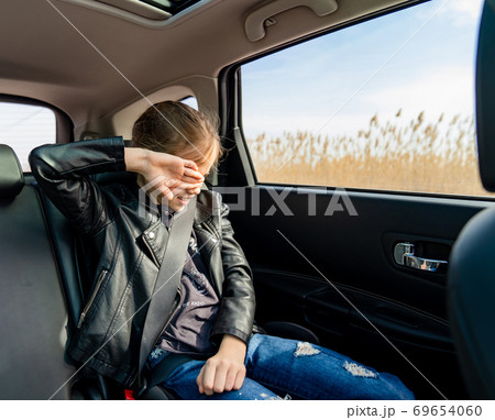 teen girl in leather jacket crying seat back car 69654060