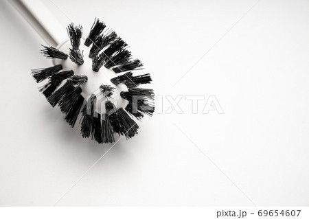 a toilet brush on a white background. close-up. a toilet brush on a white background. close-up. 69654607