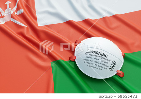 Coronavirus medical surgical face mask on the Omani national flag 69655473