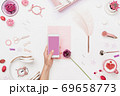 Smartphone in woman hand above artist workplace 69658773