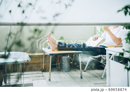 自宅のベランダでリモートワークする男性（顔無し） 69658874