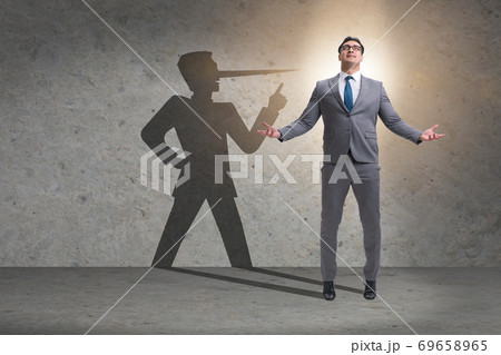Concept of businessman liar with his shadow 69658965