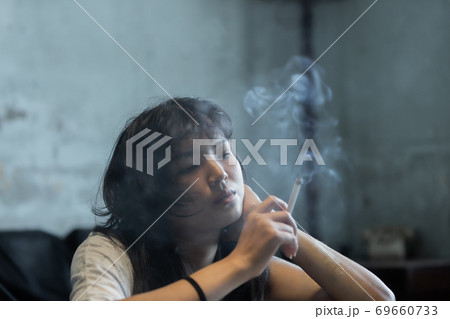 Asian girl smoking and feeling be absent-minded 69660733