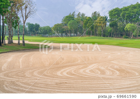 Golfcourse, Beautiful landscape of a golf court with palm trees and green grass Golfcourse, Beautiful landscape of a golf court with palm trees and green grass 69661590