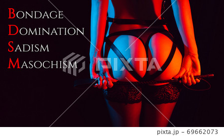 Sexy ass girl in a leather belt with a whip in her hands 69662073