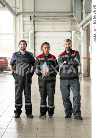 Three successful intercultural workers of contemporary car maintenance center 69662660