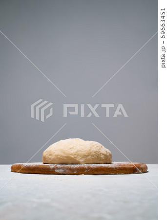 dough for pizza on white table on wooden Board dough for pizza on white table on wooden Board 69663451