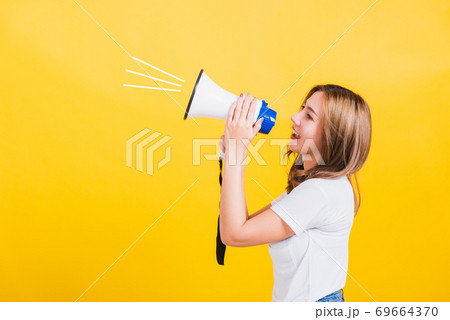 woman teen standing making announcement message shouting screaming in megaphone woman teen standing making announcement message shouting screaming in megaphone 69664370