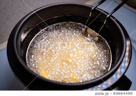 French fries. oil boiling in a deep fryer at home. 69664490