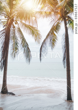 Tropical nature clean beach and white sand in summer with sun light blue sky and bokeh background. Tropical nature clean beach and white sand in summer with sun light blue sky and bokeh background. 69667527