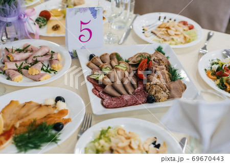various meat snacks and salads on the festive table for dinner various meat snacks and salads on the festive table for dinner 69670443