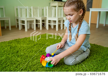 girl play with whirligig colourful musical bells 69671676